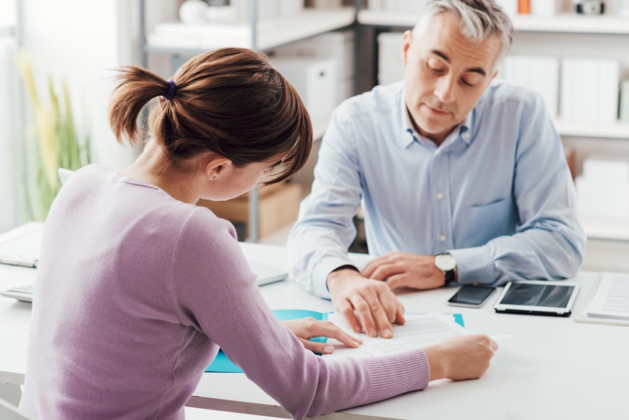 Employee and employer reading a contract.